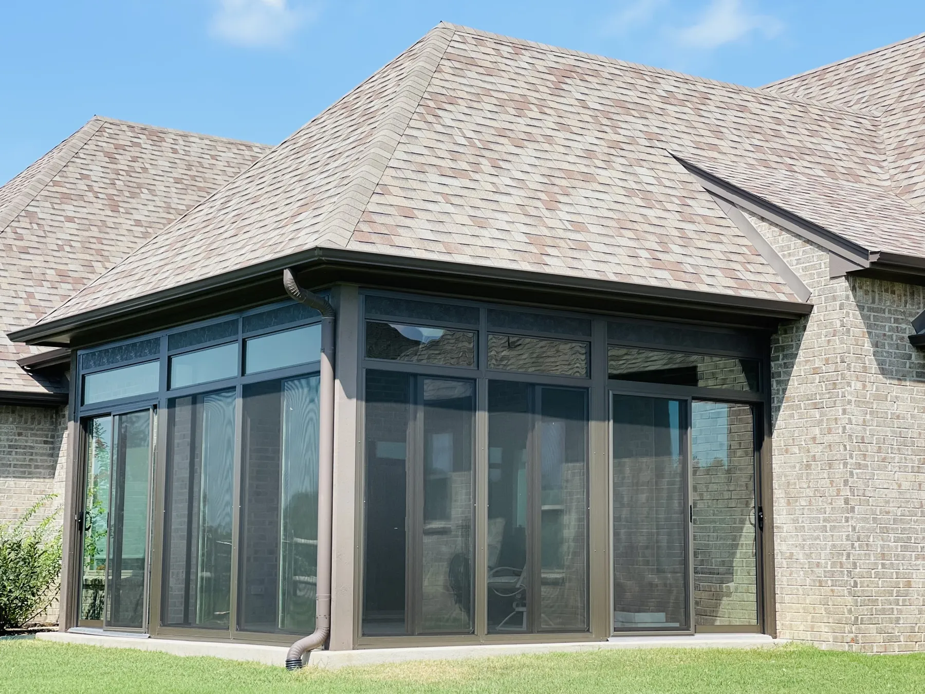 Bronze-frame glass sunroom enclosure